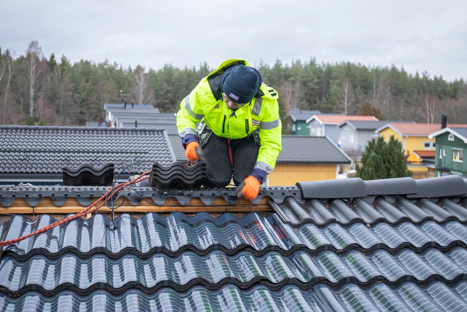 Roofers installing shingles on a building.