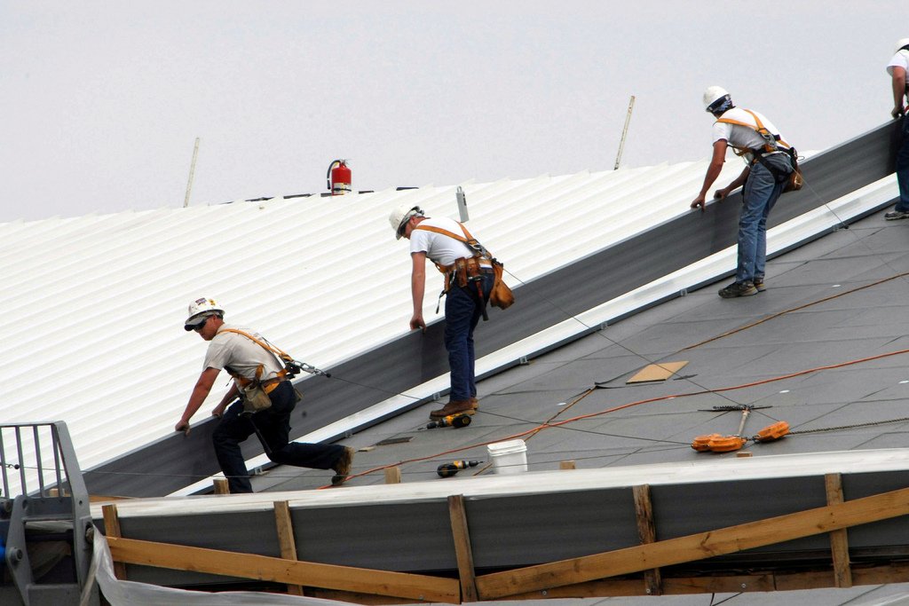 Advanced roofing contractors installing metal roof system in NYC